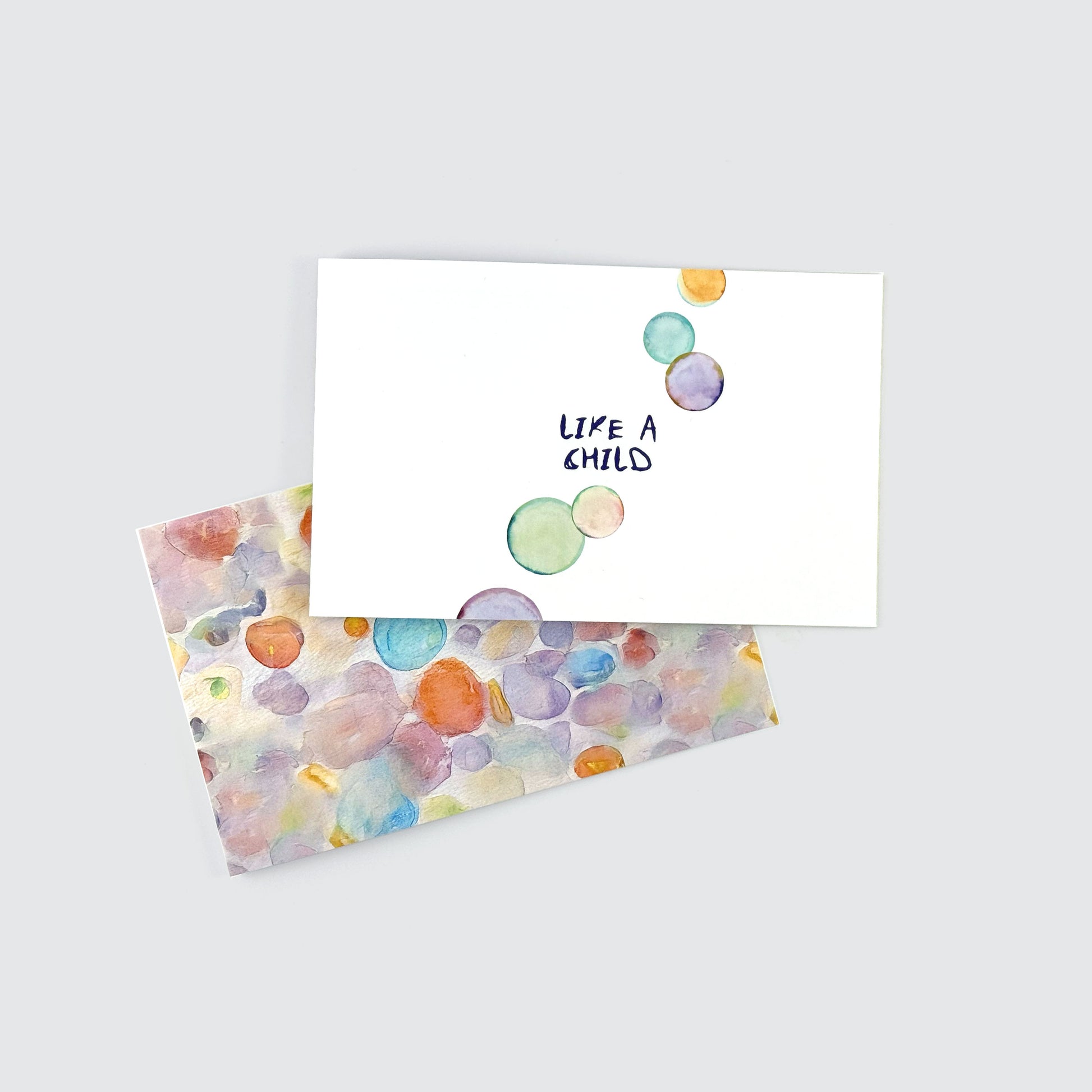 Preview of a printed devotional about childlike faith and trust with a colorful watercolor bubbles background.